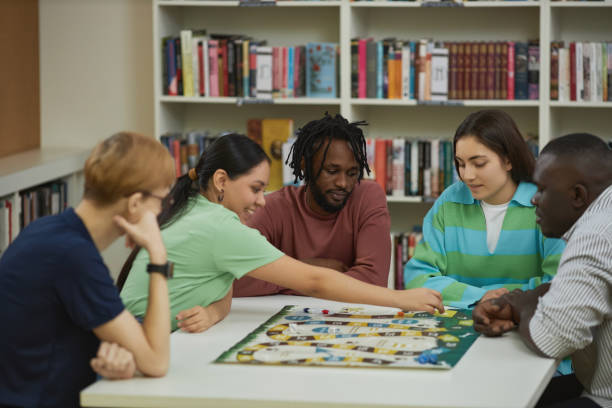 istock Multiethnic group of young people playing board games together 1485548925