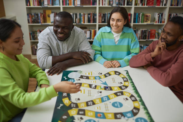 istock Group of friends playing board game together at table and having fun 1485548987