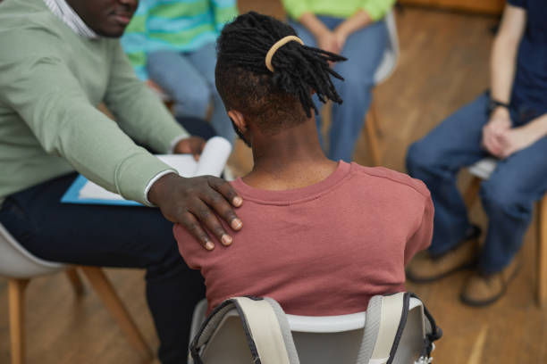 Black man crying in support group circle and sharing story