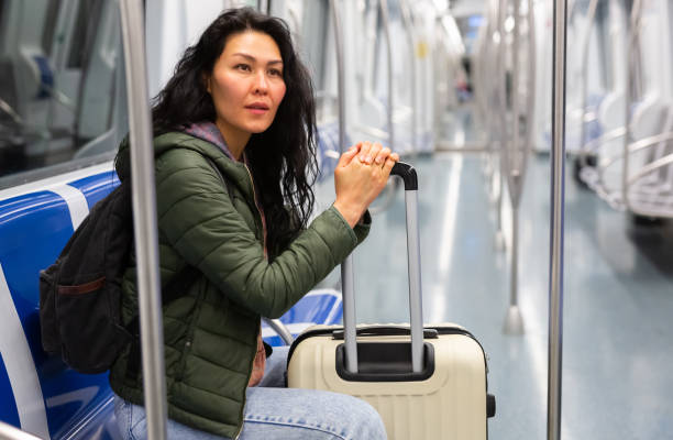 istock Young woman passenger sitting in subway car 1485549655