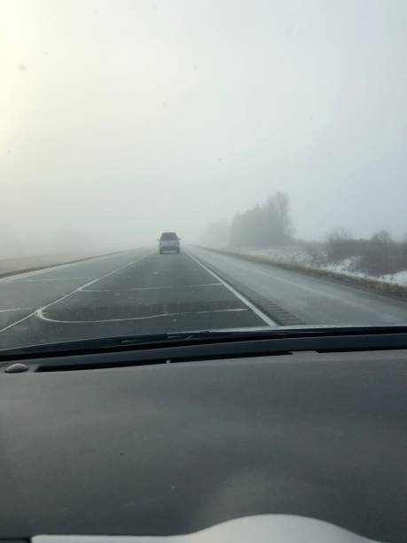istock Car driving into a snowstorm 1485556062