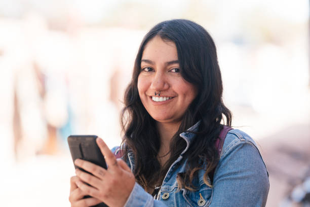 istock Woman using smartphone outdoors 1485565975