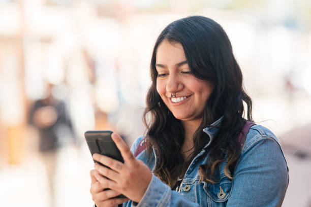 istock Woman using smartphone outdoors 1485565983