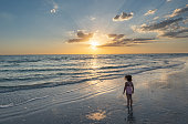 Child Playing During a Vibrant Sunset at Treasure Island Beach on the Gulf Coast of Florida USA