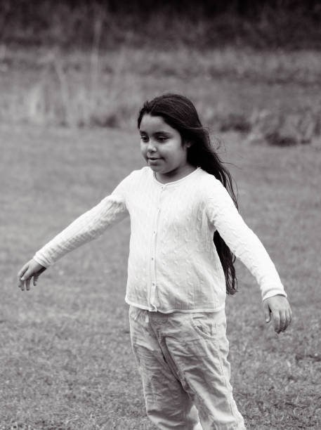 A girl on a field in black and white