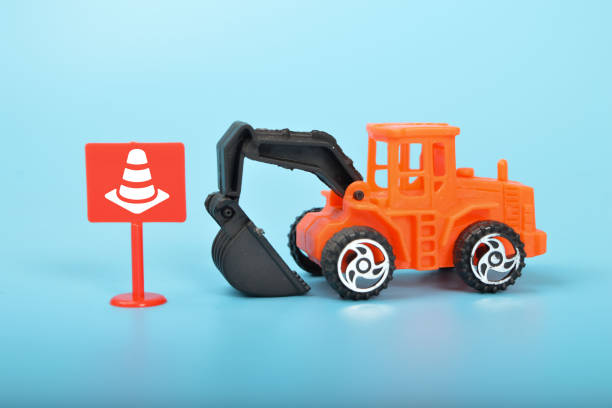 istock A toy excavator at a construction site, surrounded by safety cones, symbolizing the importance of safety measures and precautions in the construction industry. 1485574515