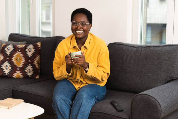 istock Young woman watching something fun on TV 1485574677