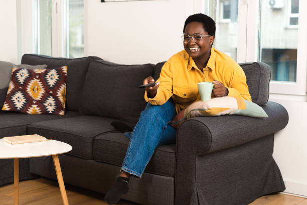 istock Young woman watching something fun on TV 1485574688