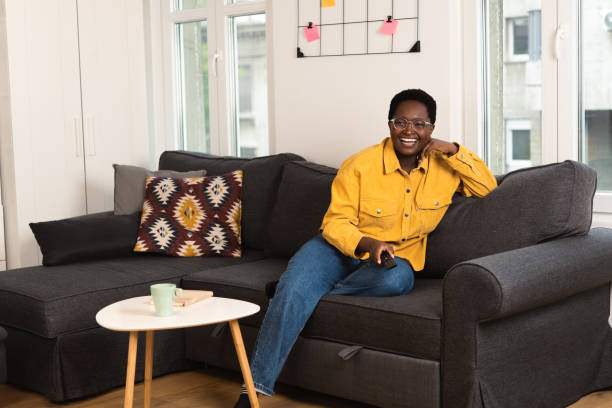 istock Happy young woman watching TV 1485574689