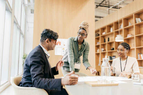 istock Female financial advisor in discussion with client in office conference room 1485575007