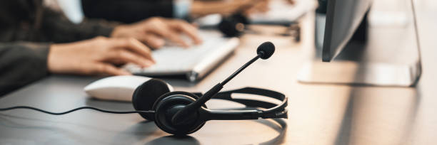 Panorama focus headset on call center workspace desk with blur operator. Prodigy Panorama focus headset on call center workspace desk with blur background of operator team or telesales representative engage in providing client with customer support service or making sales. Prodigy customer service stock pictures, royalty-free photos & images