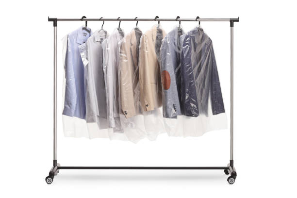 istock Clothing rack at dry cleaners with suits hanging 1485585995