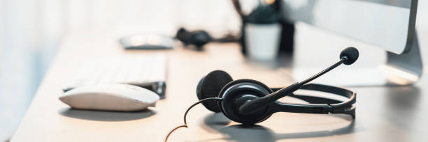 istock Panorama view of empty call center operator workspace focus on headset. Prodigy 1485588133