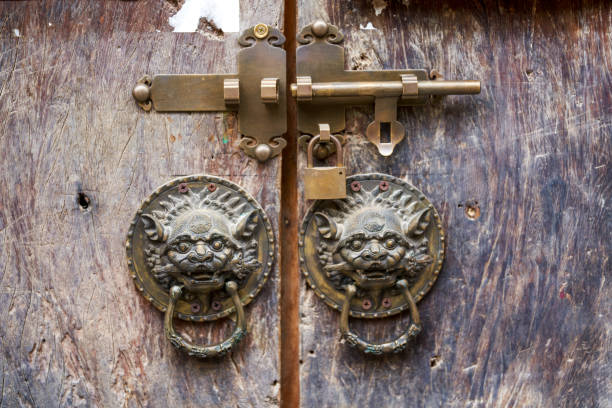 A lion head knocker on a traditional Chinese gate