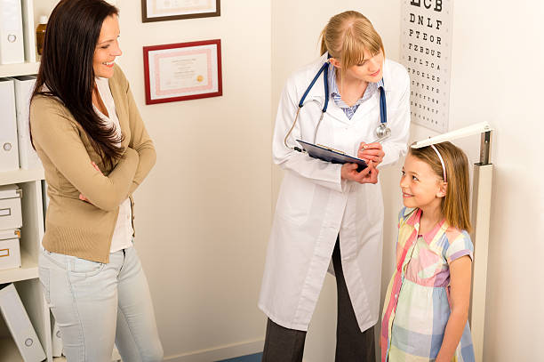 Medical check-up at pediatrist girl measure height stock photo