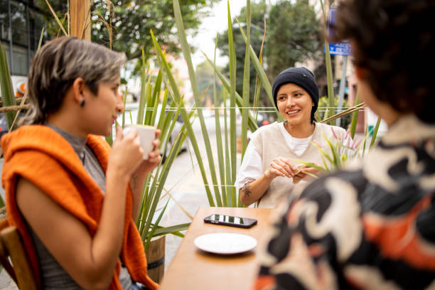 istock Three young Latin woman sitting at local cafeteria and having fun 1485598434