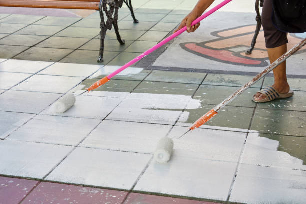 istock Worker holding  paint roller and painting footpath 1485603011