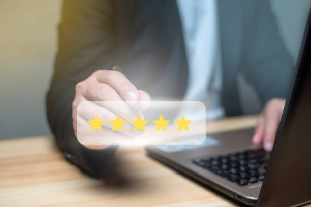 istock Man using laptop and touch virtual screen and give five star symbol to increase rating of product and service concept, Customer satisfaction, selective focus. 1485606935