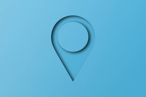 istock Light blue paper cut into placement pin shapes. pointer pad location mark Set on a light blue paper background. 1485608022