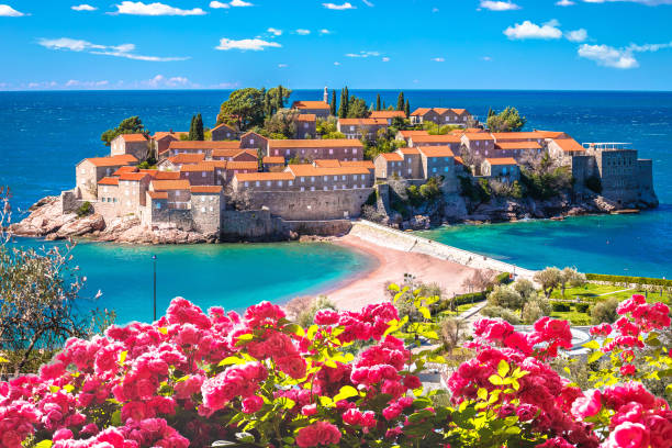 Sveti Stefan historic island village and beach view Sveti Stefan historic island village and beach view, archipelago of Montenegro montenegro stock pictures, royalty-free photos & images