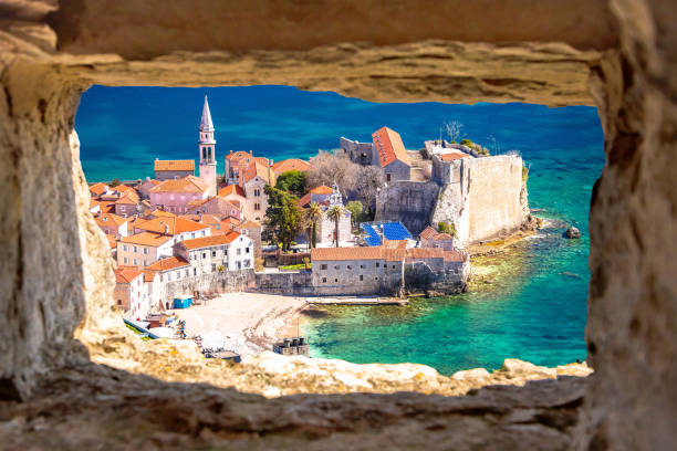 istock Historic town of Budva architecture and beach view through stone window 1485611546
