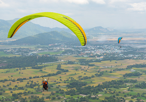 paragliders flying in the sky above the mountains on sunset