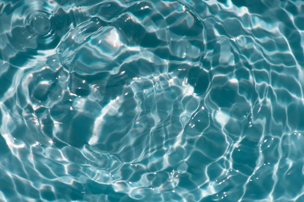 istock Blue water with ripples on the surface. Defocus blurred transparent blue colored clear calm water surface texture with splashes and bubbles. Water waves with shining pattern texture background. 1485618986