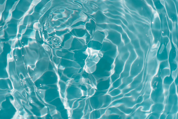 istock Blue water with ripples on the surface. Defocus blurred transparent blue colored clear calm water surface texture with splashes and bubbles. Water waves with shining pattern texture background. 1485619668