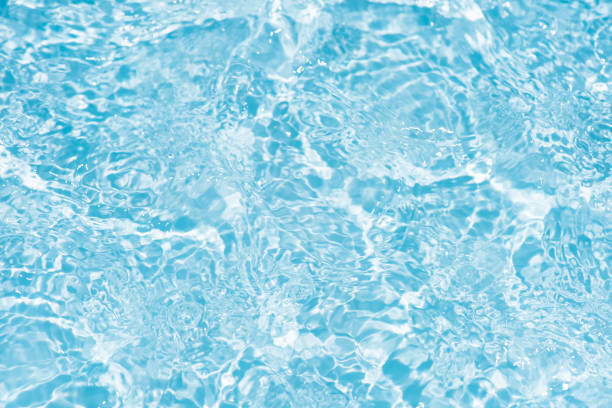istock Blue water with ripples on the surface. Defocus blurred transparent blue colored clear calm water surface texture with splashes and bubbles. Water waves with shining pattern texture background. 1485619698