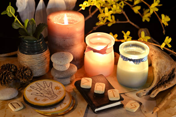 istock Esoteric and occult still life with vintage magic objects, runes and burning candles on witch table altar for mystic rituals and fortune telling. Halloween and gothic background 1485625491