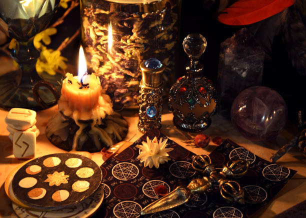 istock Esoteric and occult still life with vintage magic objects, tarot cards and burning candle on witch table altar for mystic rituals and fortune telling. Halloween and gothic background 1485625683