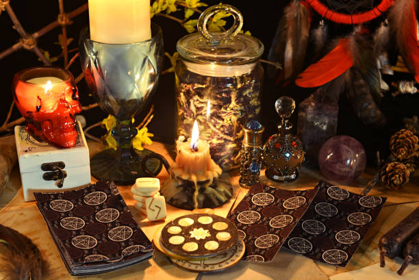 istock Esoteric and occult still life with vintage magic objects, tarot cards and burning candles on witch table altar for mystic rituals and fortune telling. Halloween and gothic background 1485625765