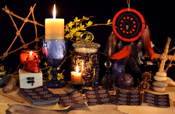 istock Esoteric and occult still life with vintage magic objects, tarot cards and burning candles on witch table altar for mystic rituals and fortune telling. Halloween and gothic background 1485625918