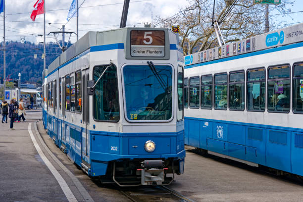 stazione del tram bellevue square con tram e bandiera svizzera che sventola nel vento alla città svizzera. - zurich switzerland snowman swiss culture foto e immagini stock