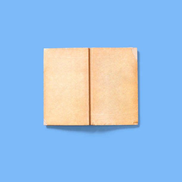 istock Soft book cover upside down open , isolated on blue background. vintage concept. 1485631352