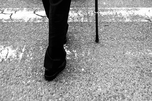 Image of a man's leg with a cane
