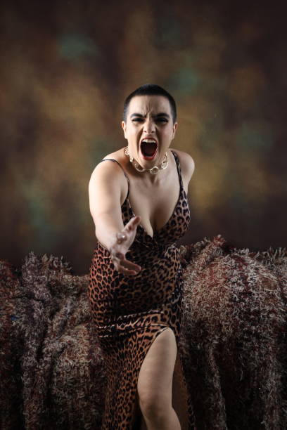 Displeased Party woman throwing bottle in anger. Displeased Party woman throwing bottle in anger. Mad sexy young woman in isolated background screams annoyed. Loud noise, furious angry millennial Indian girl yell shout bothered by noisy disturbing sound. vex nightclub stock pictures, royalty-free photos & images