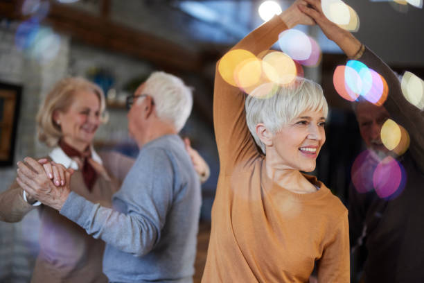 istock Carefree senior couples dancing at home party. 1485645807
