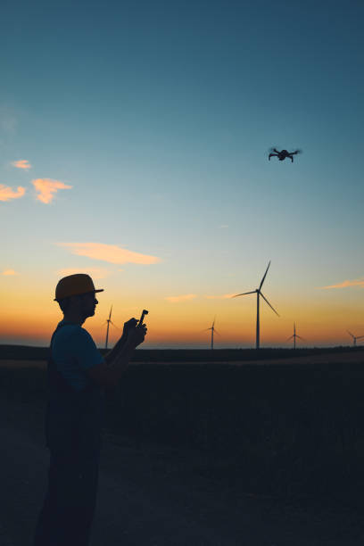 istock Engineer mechanic using drone for inspection in a windmill farm park. 1485647492