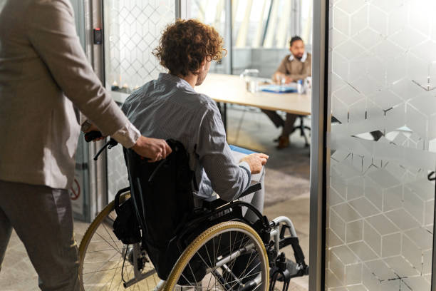 istock Business colleague assisting a candidate in a wheelchair on a job interview. 1485649521