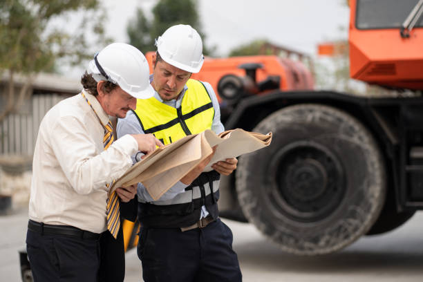 istock Portrait caucasian engineer man use paper work working with team engineer and crane truck background at precast site work 1485653806