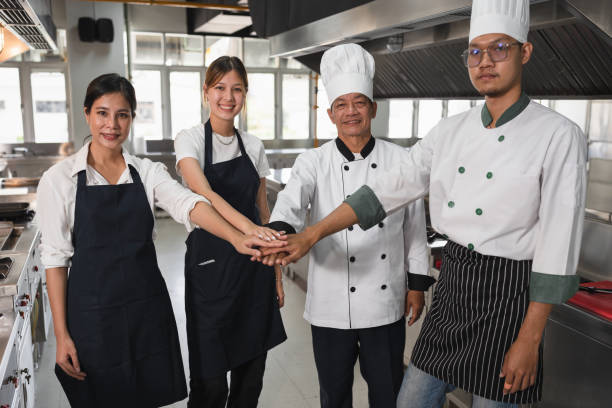 istock Join hand team Asia chef at big kitchen 1485656242