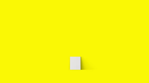 istock 3d rendering laying empty blank white canvas isolated on yellow background. 1485658120