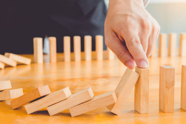 istock Concepts of business planning, high-performance business processes and workflows, Businessman plan and strategy in business Domino Effect Problem Solving 1485659325