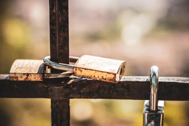 Photo of Grille with padlocks in Granada. Grille with padlocks at the entrance of the gardens of Carmen de los Martires.