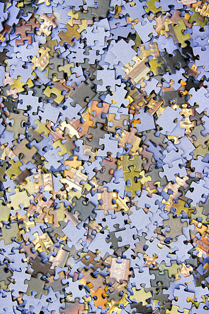istock Pieces of puzzle spilled on table 148566203
