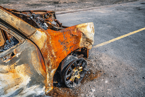 Burnt car on the side of the road