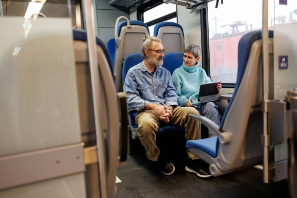 istock Mature couple using digital tablet while traveling by train 1485663460