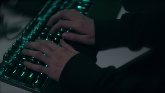 Caucasian Hands Typing on Lit-Up Keyboard