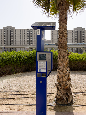 Dubai, United Arab Emirates - 7th October, 2021 : a modern smart solar powered parking meter with latest technology in Dubai.